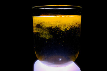 Close-up: Turmeric Particles Dispersing in Water