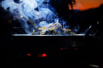beautiful smoke of Thai BBQ buffet or Thai-style Barbecue in dark night