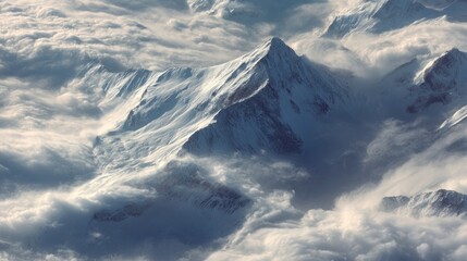 Majestic snow mountain peak above clouds aerial view