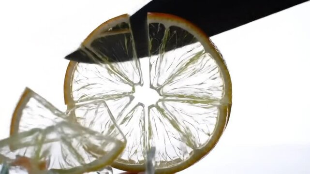 A solid glass orange is cut cleanly in half, revealing a crystal-clear slice.