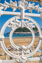 La Concha Beach with turquoise sea and iconic white fence in Donostia Spain