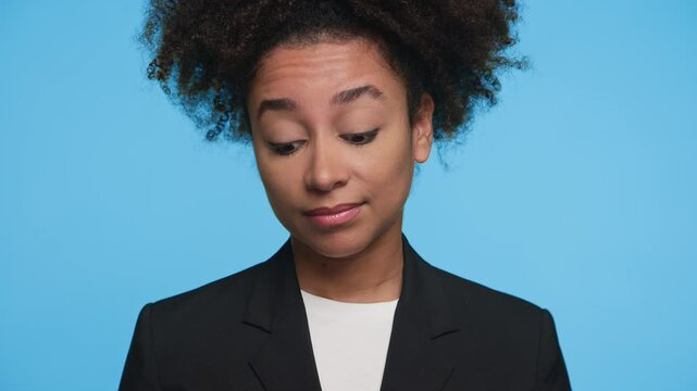 Skeptical young businesswoman looking sideways with uncertain expression