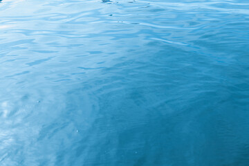 Calm turquoise waters reflect the sunlight on a serene day at the beach