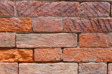 Brick wall texture showcasing vibrant colors and patterns in daylight