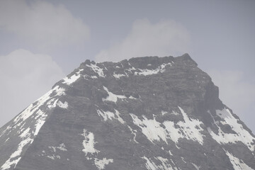 Riga, Latvia 05-09-2024 A Serene Mountain Standing Tall Against a Cloudy Sky