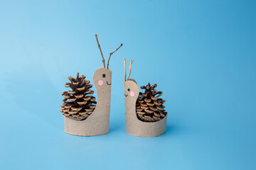 Autumn kids craft project with snails made from recycled paper rolls and pine cones, ideal for schools, eco education, DIY books, parenting blogs, seasonal branding, early learning studios,