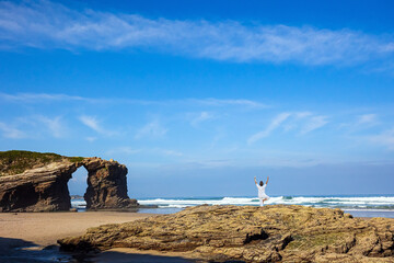 Woman in white on a rock