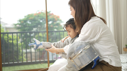 A girl in fencing gear with their mother preparing sports equipment