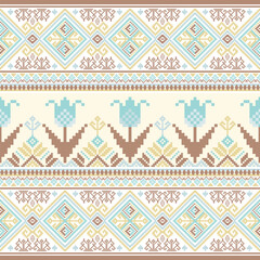 A light-toned pixel art pattern combining tribal elements and large stylized flowers, rendered in cream, blue, and brown tones.
