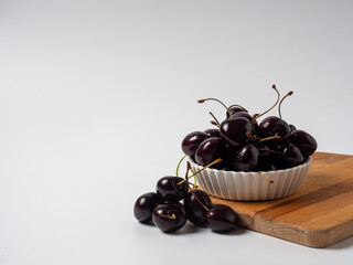 Sweet cherries with apricots isolated on white background cutout. Ripe berries closeup. Mix berries and fruits.