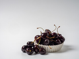 Sweet cherries with apricots isolated on white background cutout. Ripe berries closeup. Mix berries and fruits.