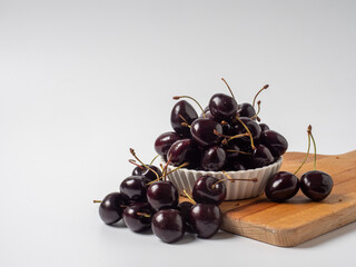 Sweet cherries with apricots isolated on white background cutout. Ripe berries closeup. Mix berries and fruits.