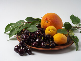 Sweet cherries with apricots isolated on white background cutout. Ripe berries closeup. Mix berries...