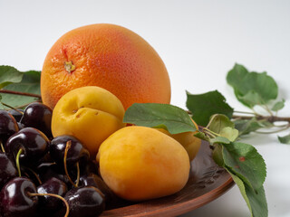 Sweet cherries with apricots isolated on white background cutout. Ripe berries closeup. Mix berries...