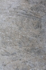 Closeup of a cracked and weathered concrete surface showing intricate textures