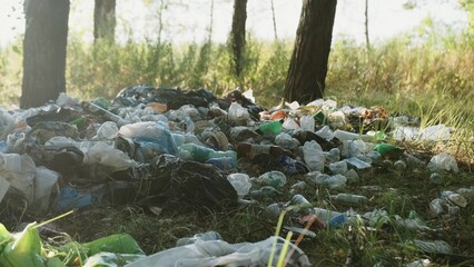 Different garbage and trash on a ground in the forest