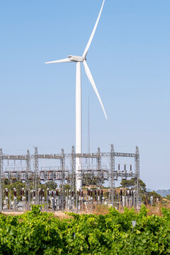 Wind turbine beside vineyard and electric station infrastructure in Terra Alta, Catalonia, Spain, capturing sustainable energy transition in Mediterranean agriculture and technological coexistence.
