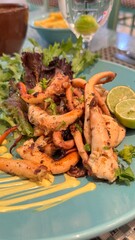 Grilled octopus served with potatoe and garlic sauce, directly above view