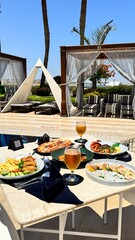 Served dining table.pizza.meat.shrimps salad avocado.Turkish dish featuring doner meat French fries...