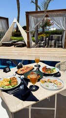 Served dining table.pizza.meat.shrimps salad avocado.Turkish dish featuring doner meat French fries...