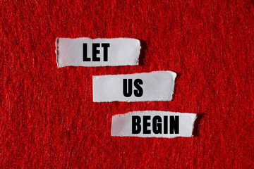 Let us begin message written on ripped torn white paper pieces on red background. Conceptual let us...
