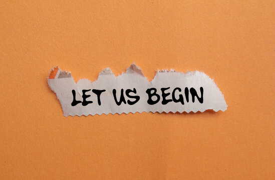 Let us begin message written on ripped torn newspaper piece on orange background. Conceptual let us begin symbol. Copy space.