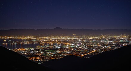Breathtaking night cityscape view with distant mountains and starry sky