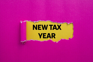 New tax year message written on ripped torn pink paper on yellow background. Conceptual new tax year symbol. Copy space.