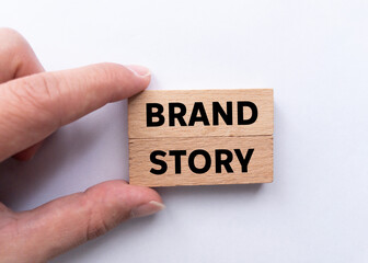 Brand story message written on wooden blocks on white background. Conceptual brand story symbol. Copy space.