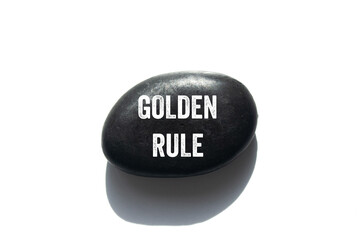 Golden rule message written on black stone on white background. Conceptual golden rule symbol. Copy...