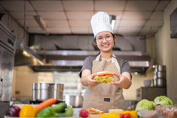Young woman learning to cook, sandwiches and fresh vegetables placed on the table in a modern kitchen.