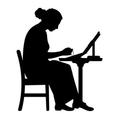 Female silhouette focused on drawing at an easel while sitting  