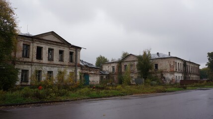 A row of abandoned buildings on the side of a road