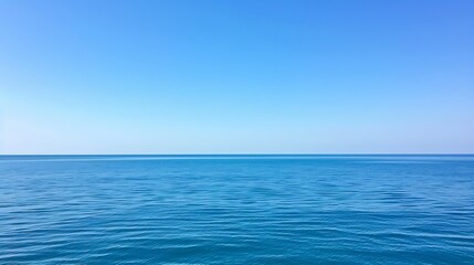 Obraz premium Vast expanse of cerulean sky meets the tranquil turquoise waters of the ocean surface