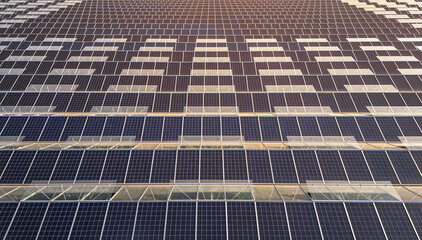 Greenhouse for growing vegetables with mounted photovoltaic solar panels on the roof, combining...