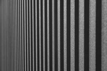 Corrugated metal sheet surface with diagonal ridges, showing detailed texture and pattern commonly...