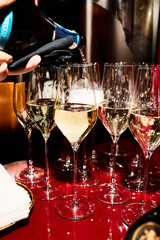 Pouring champagne into elegant  glass	