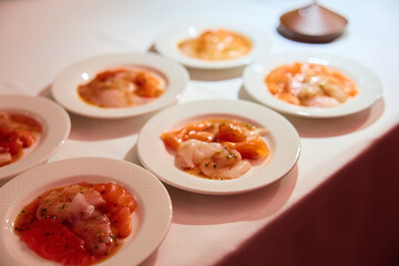 Gourmet Fish Carpaccio with Herbs on White Plate