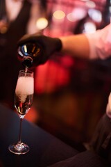 Pouring champagne into elegant  glass	