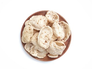 Kerupuk tempe on wooden plate, Indonesian traditional snack made from soybean fermentation and flour. Flat lay 