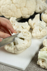 The Process of Slicing Raw Fresh Cauliflower.