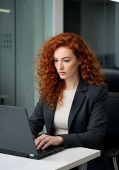 Focused Professional Financial IT Specialist with Wavy Red Hair Working on Laptop in Office