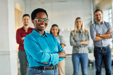 Portrait of a group of young business people having a meeting in the office. Teamwork and success concept, portrait of a smart young businesswoman