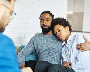 Father with his teenage son at meeting with social worker, psychologist discussing mental health...