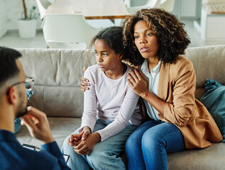 Mother with her teenage daughter at meeting with social worker, psychologist discussing mental...