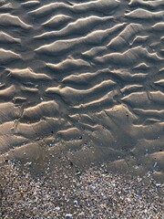 gray beach wavy sand ripples dune texture wallpaper pattern background close-up