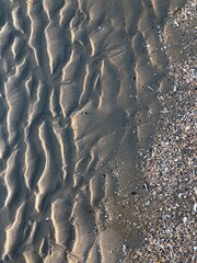 gray beach wavy sand ripples dune texture wallpaper pattern background close-up