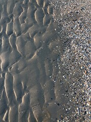 gray beach wavy sand ripples dune texture wallpaper pattern background close-up