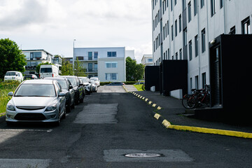 Urban residential area with parked cars and bright housing in Reykjavik, Iceland