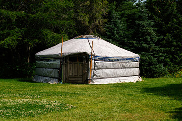 Traditional round yurt surrounded by trees in Reykjavik, Iceland on a sunny day